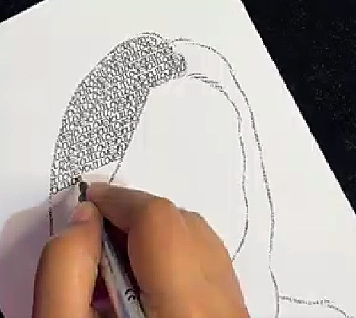 An artist's hand writing words into the hair of a portrait outline