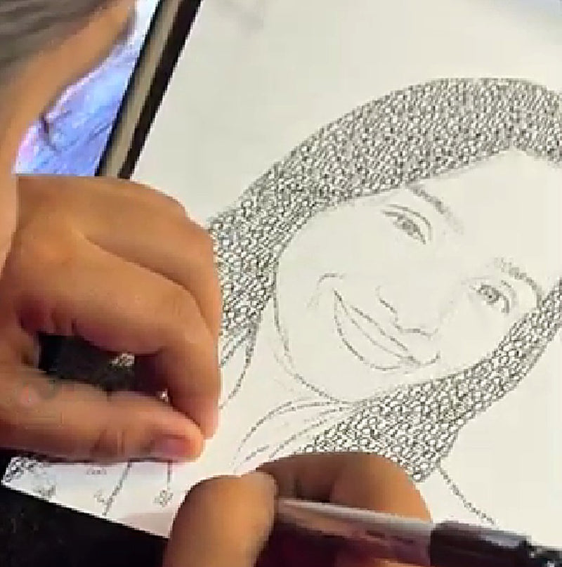 An artist drawing a smiling face made of words